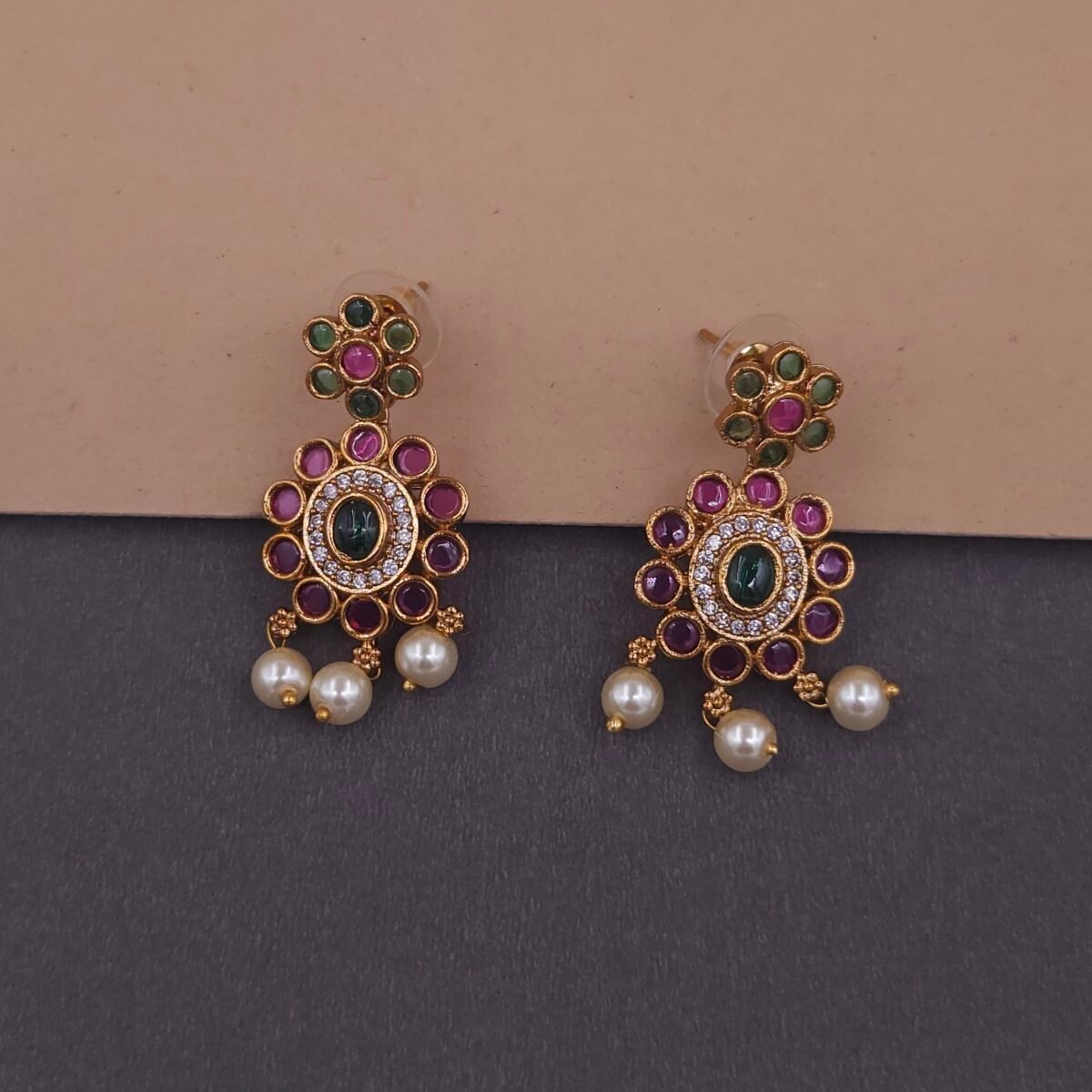 Khianaa temple necklace set displayed on bust with matching studs green pink pearls brass finish