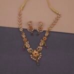 Khianaa temple jewelry necklace set closeup with peacock lotus motifs and ruby emerald stones