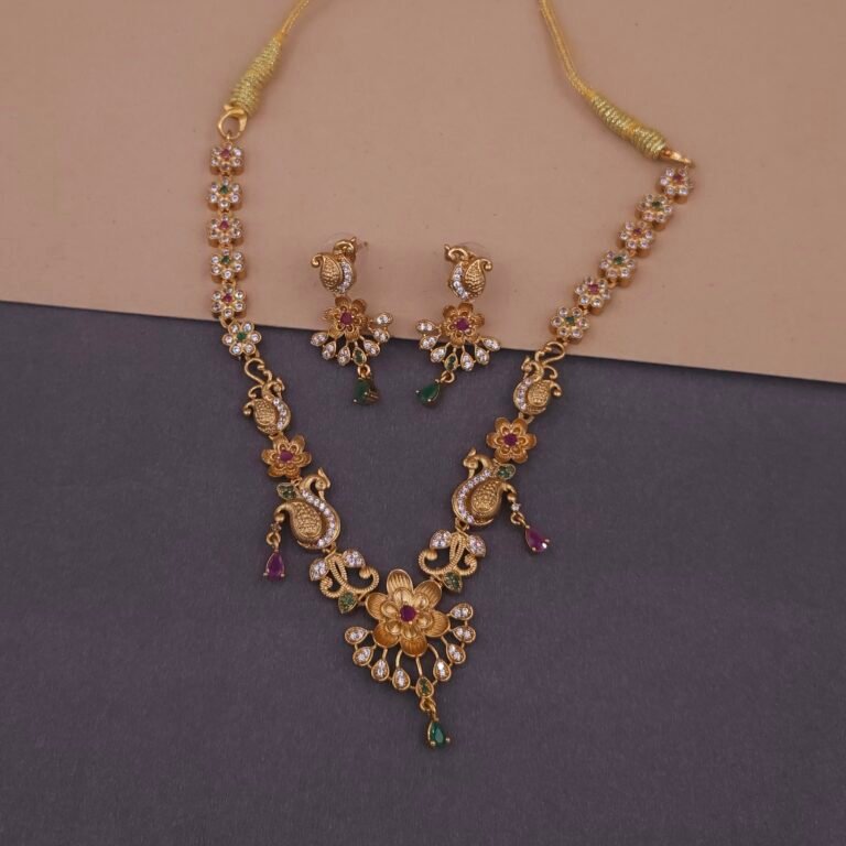 Khianaa temple jewelry necklace set closeup with peacock lotus motifs and ruby emerald stones