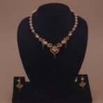 Khianaa peacock motif earrings and necklace set side angle with dangling green drops