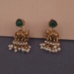 Khianaa temple earrings closeup featuring elephant motifs green stones and pearl strands