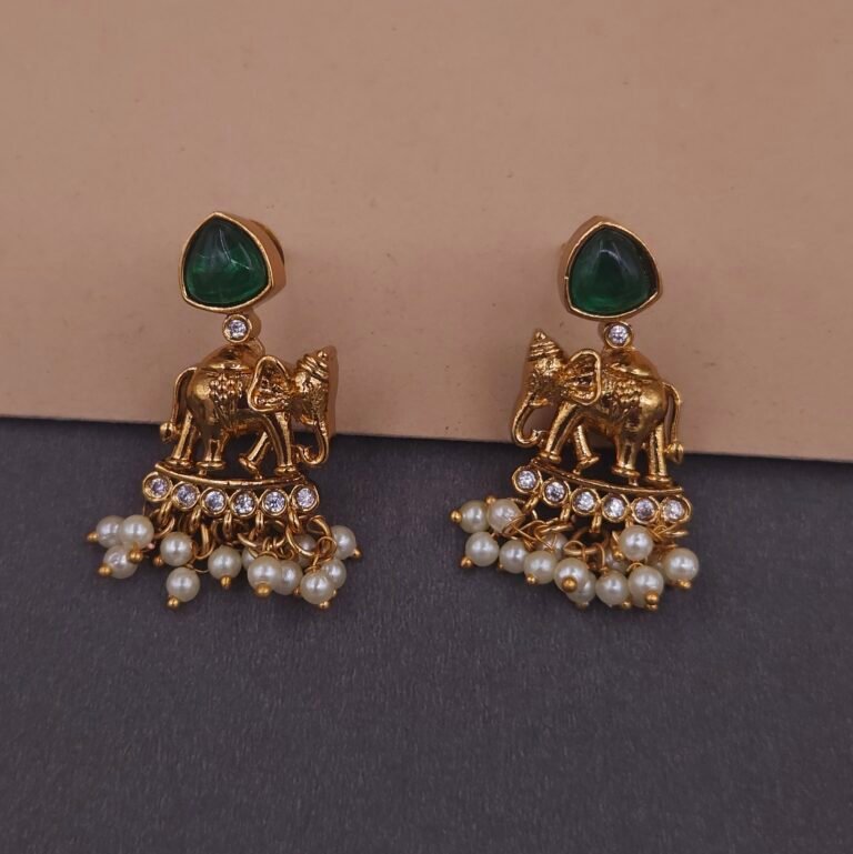 Khianaa temple earrings closeup featuring elephant motifs green stones and pearl strands